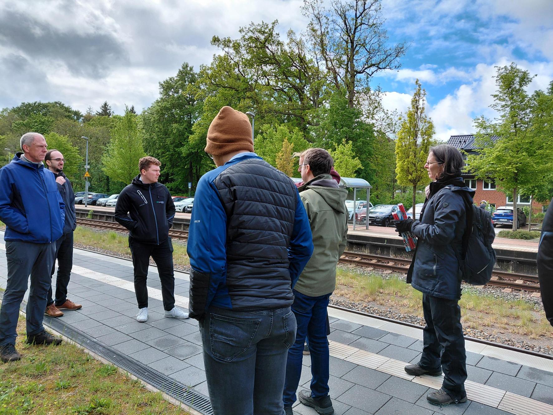 Menschen stehen an einem Gleis